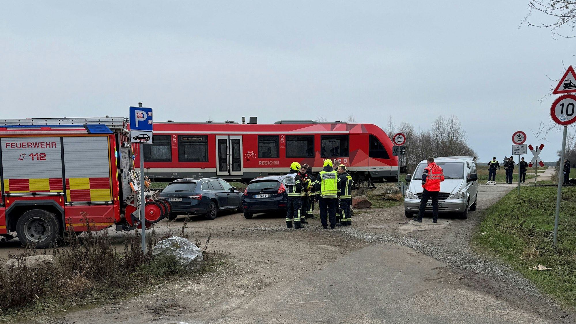 Das Bild zeigt einen Zug und mehrere Feuerwehrleute