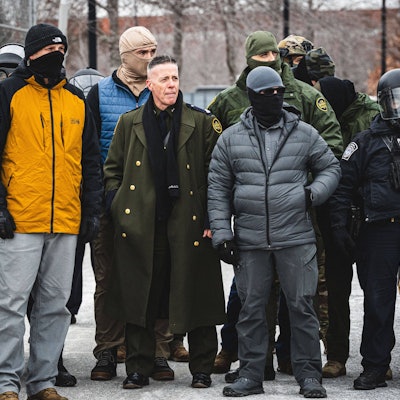 January 15, 2026, Minneapolis, Minnesota, USA: Border Chief GREGORY BOVINO observes a protest as community members gather at the entrance of the Whipple Building in Minneapolis to rally in solidarity with their neighbors whom are being detained by U.S. ICE Immigration and Customs Enforcement agents Minneapolis USA.