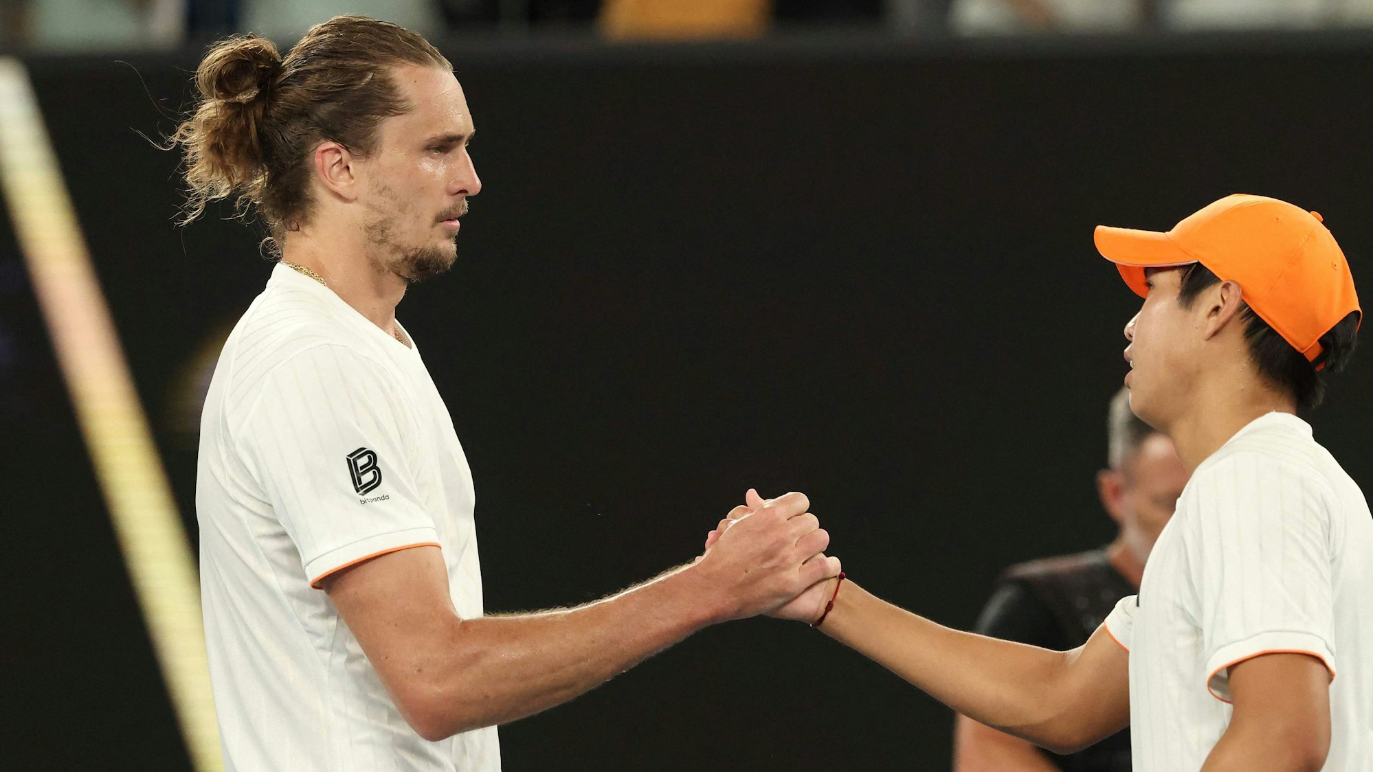 Germany's Alexander Zverev (L) shakes hands with USA's Learner Tien after their men's singles quarter-final match on day ten of the Australian Open tennis tournament in Melbourne on January 27, 2026. (Photo by DAVID GRAY / AFP) / -- IMAGE RESTRICTED TO EDITORIAL USE - STRICTLY NO COMMERCIAL USE --