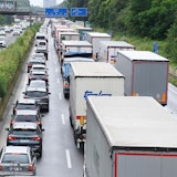 Pkw und Lkw stauen sich auf einer Autobahn.
