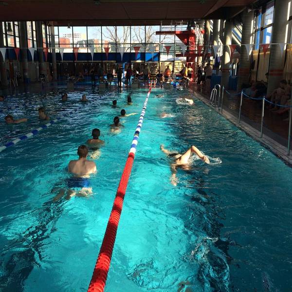 Auf dem Foto sind Badegäste im Becken eines Hallenbades zu sehen.