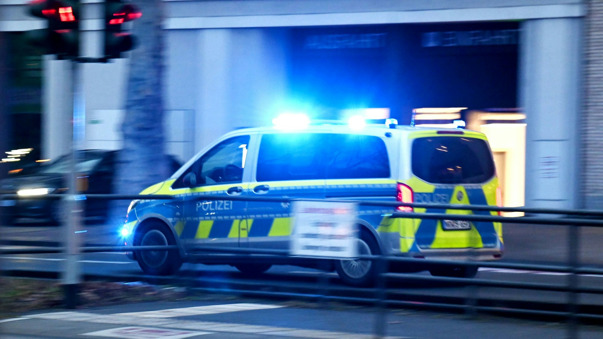 Ein Polizeifahrzeug fährt mit Blaulicht und hoher Geschwindigkeit auf der Cäcilienstraße.