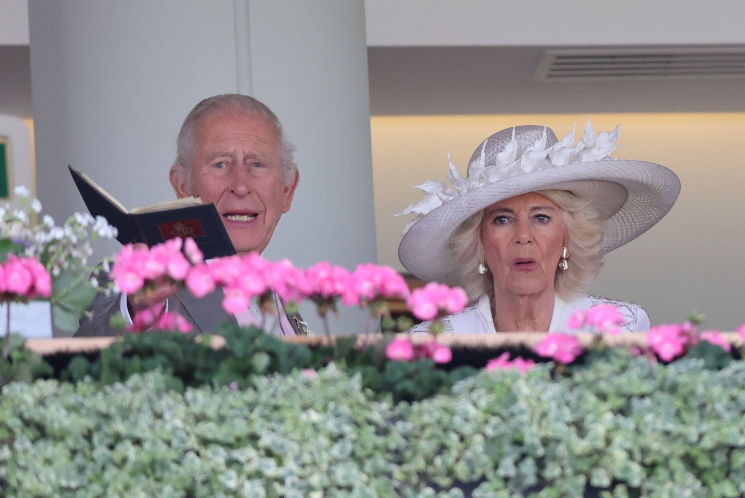 König Charles III und Königin Camilla mit Blumen.