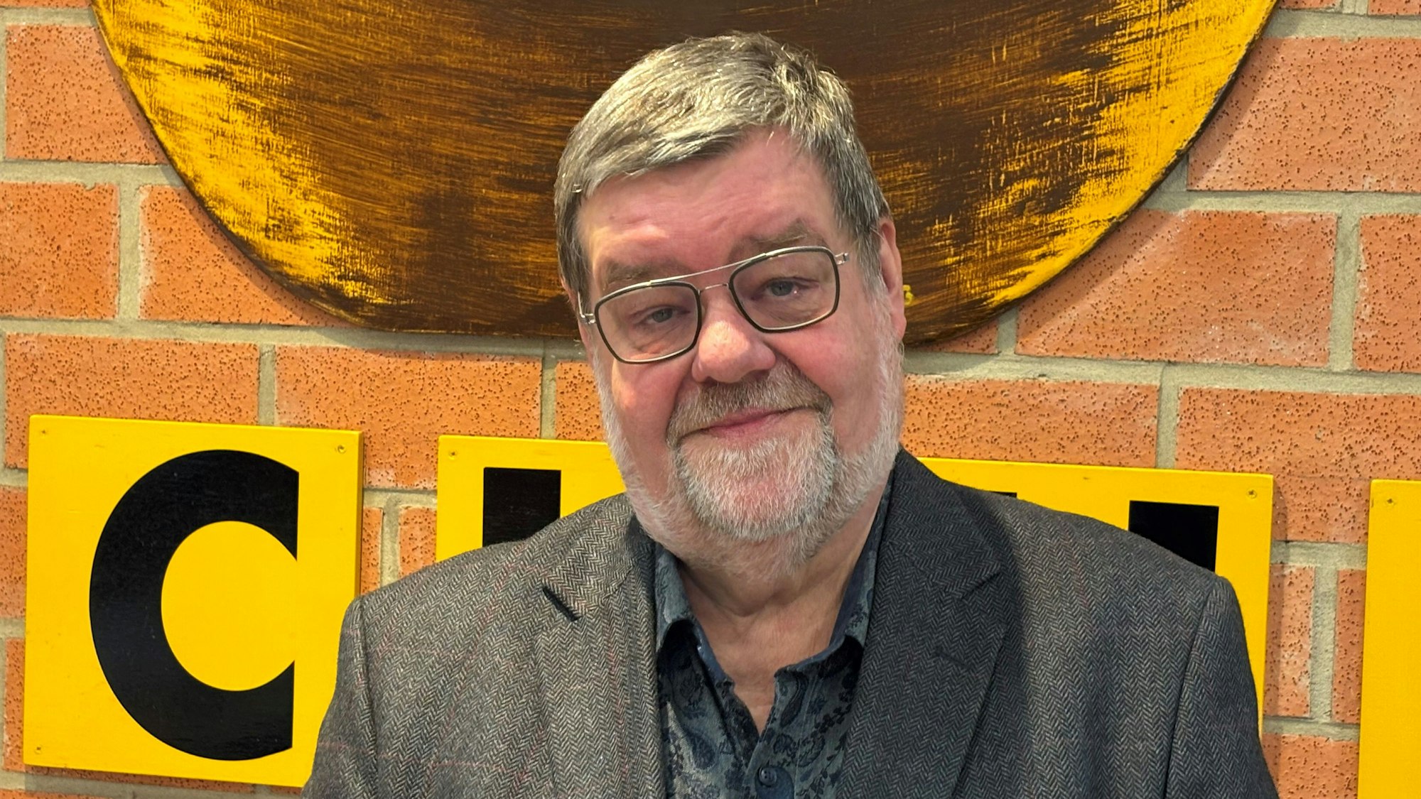 Auf dem Bild ist ein Mann in Jackett und Hemd zu sehen.