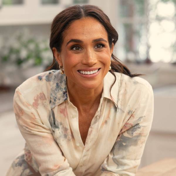 Meghan Markle lächelnd in einem Hemd.