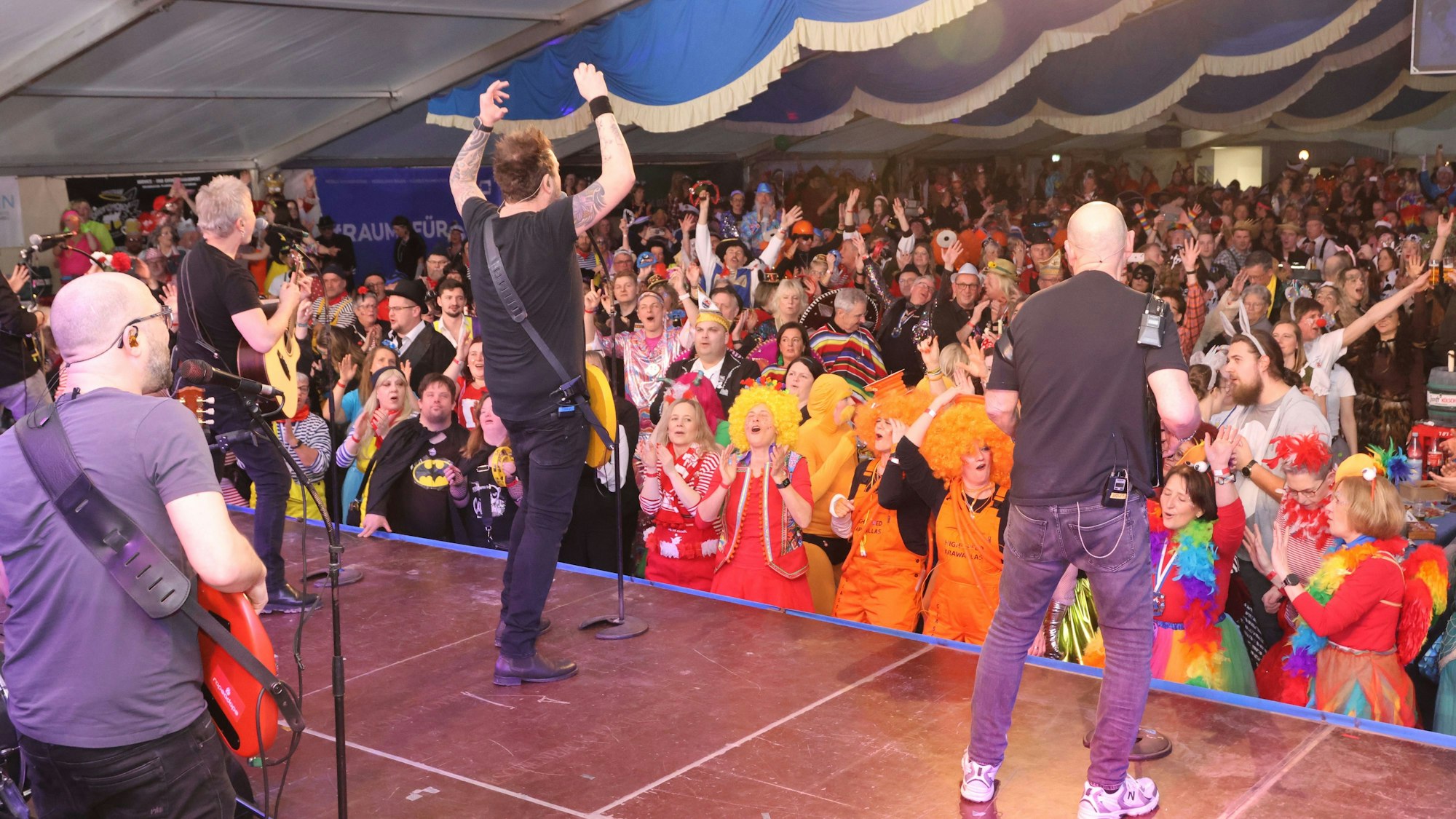 Die Band Paveier auf der Bühne einer Karnevalssitzung in einem Festzelt.