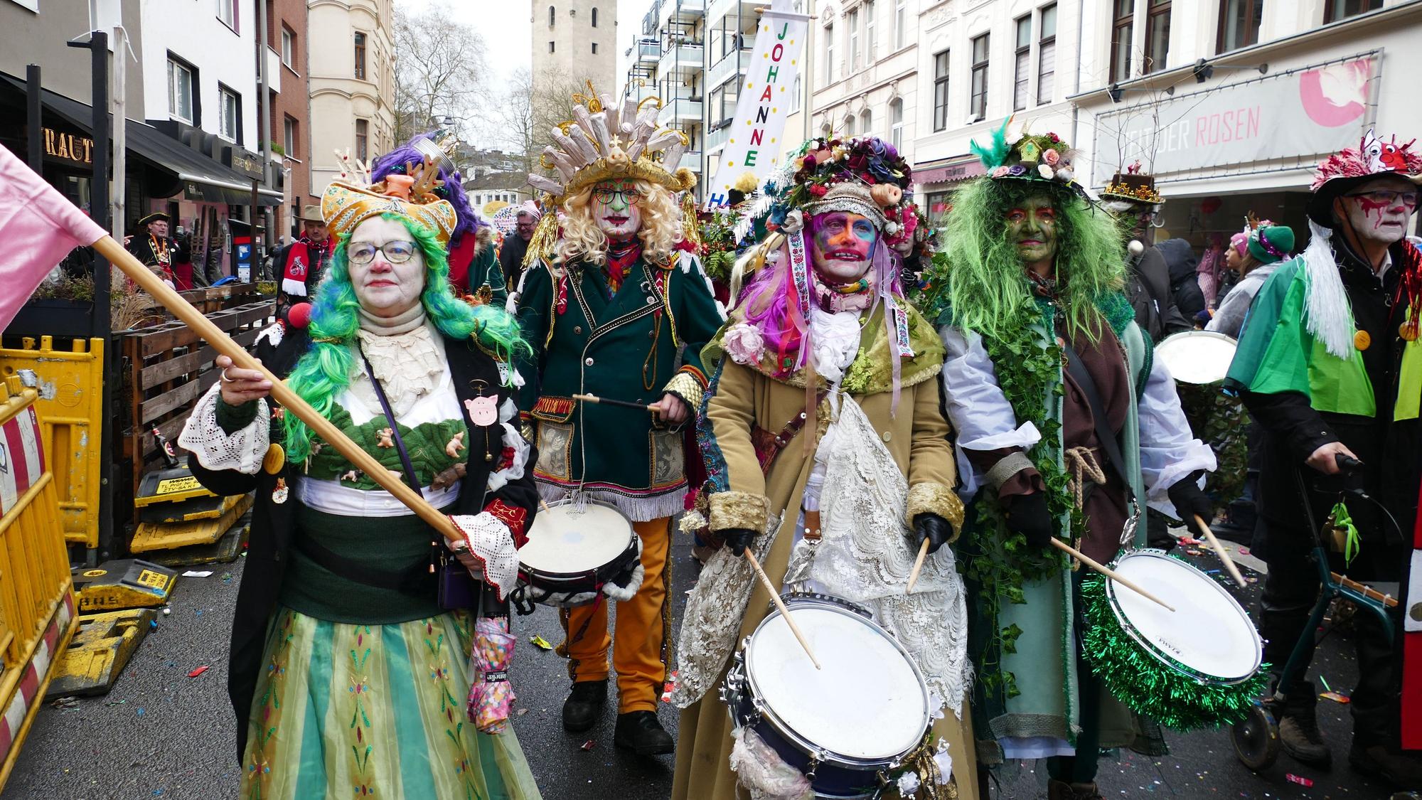 Eine Gruppe Trommler zieht eine Straße entlang.