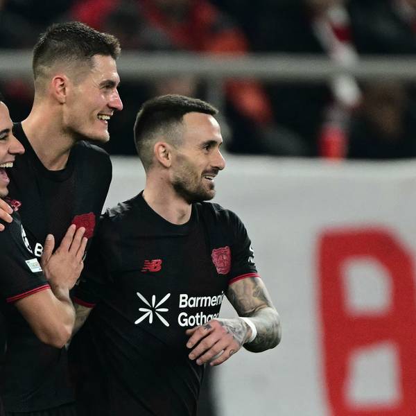 Bayer Leverkusen's Czech forward #14 Patrik Schick (C) celebrates with Bayer Leverkusen's Spanish defender #21 Lucas Vazquez (L) and Bayer Leverkusen's Spanish midfielder #24 Alex Garcia Serrano (R) after scoring Bayer Leverkusen' second goal during the UEFA Champions League knockout round play-off first leg football match between Olympiacos FC (GRE) and Bayer Leverkusen (GER) at the Karaiskakis Stadium in Piraeus, near Athens, on February 18, 2026. (Photo by Angelos Tzortzinis / AFP)