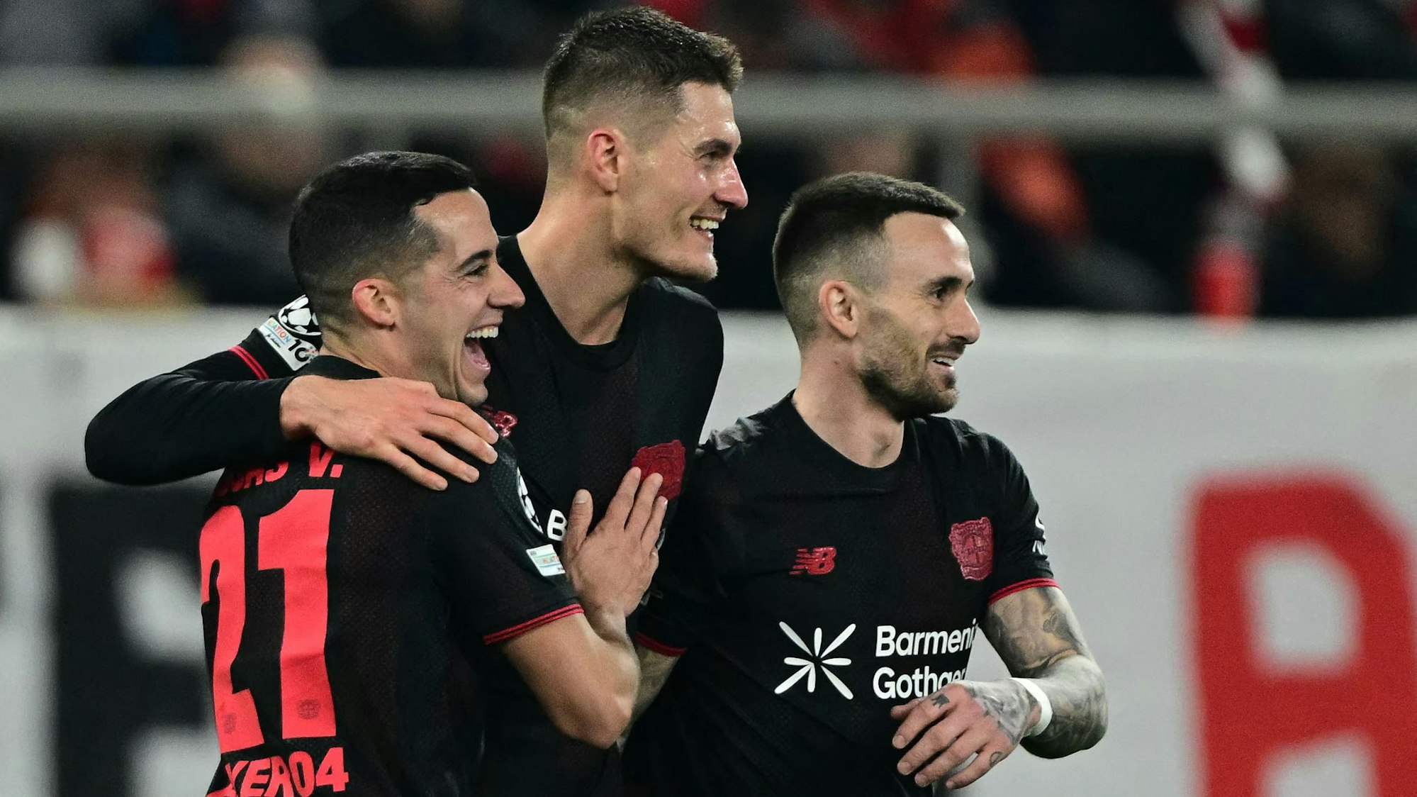 Bayer Leverkusen's Czech forward #14 Patrik Schick (C) celebrates with Bayer Leverkusen's Spanish defender #21 Lucas Vazquez (L) and Bayer Leverkusen's Spanish midfielder #24 Alex Garcia Serrano (R) after scoring Bayer Leverkusen' second goal during the UEFA Champions League knockout round play-off first leg football match between Olympiacos FC (GRE) and Bayer Leverkusen (GER) at the Karaiskakis Stadium in Piraeus, near Athens, on February 18, 2026. (Photo by Angelos Tzortzinis / AFP)