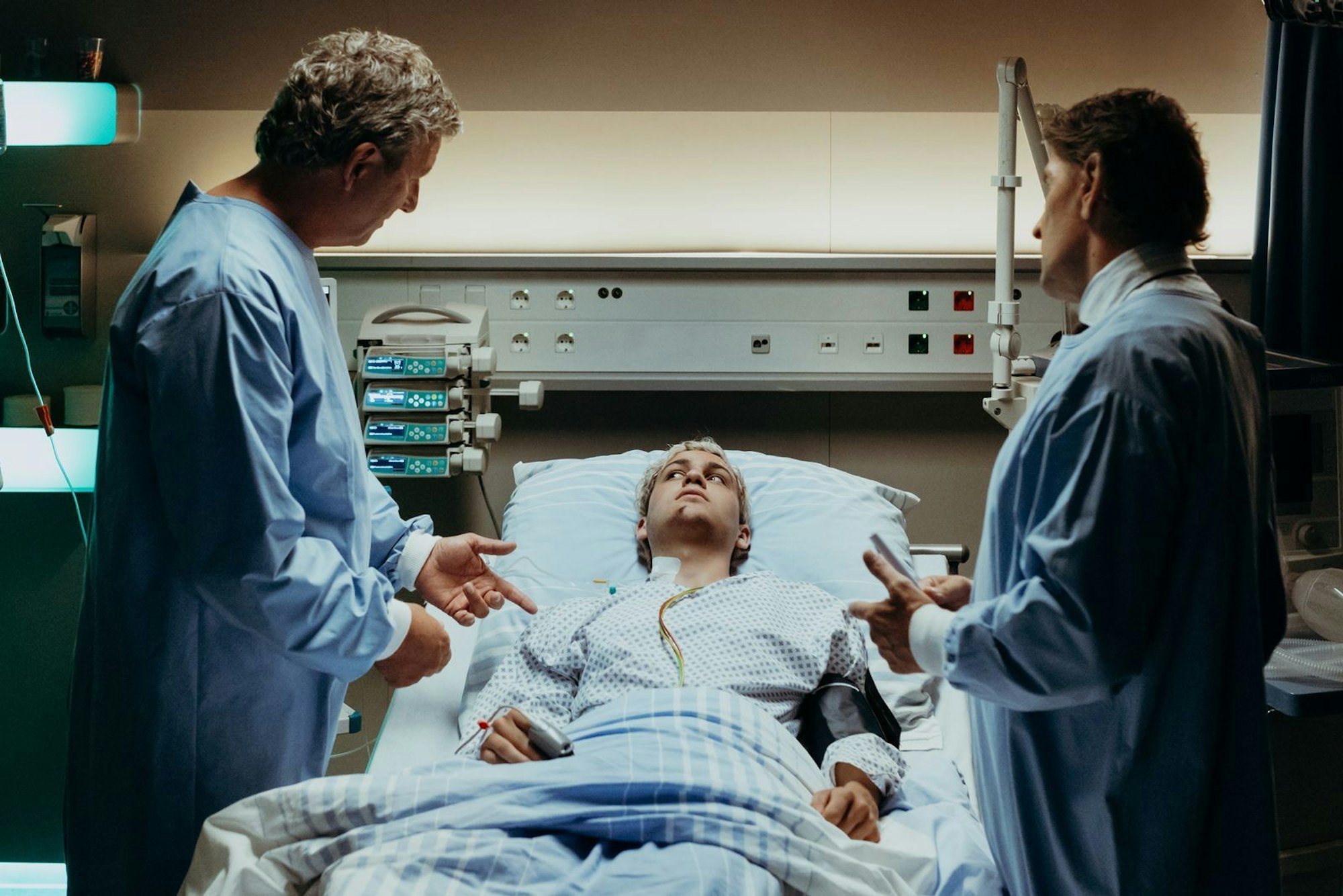 Xaver Hofinger (David Ali Rashed) ist nach seinem Unfall aus dem künstlichen Koma erwacht. Dr. Berger (Hans Sigl, links) und Dr. Kahnweiler (Mark Keller, rechts) untersuchen ihn. (Bild: ZDF/Sabine Finger Fotografie)