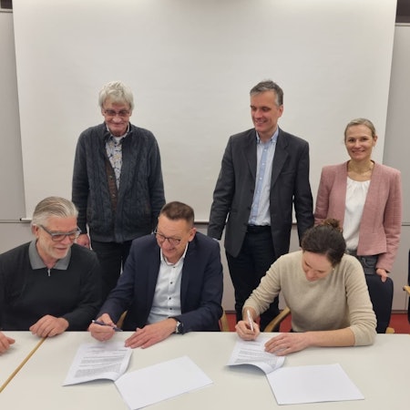 Die Stadt Burscheid und die Genossenschaft Bürgerenergie Bergisch Gladbach unterzeichnen den Vertrag für die Dachnutzung der Johannes-Löh-Gesamtschule.