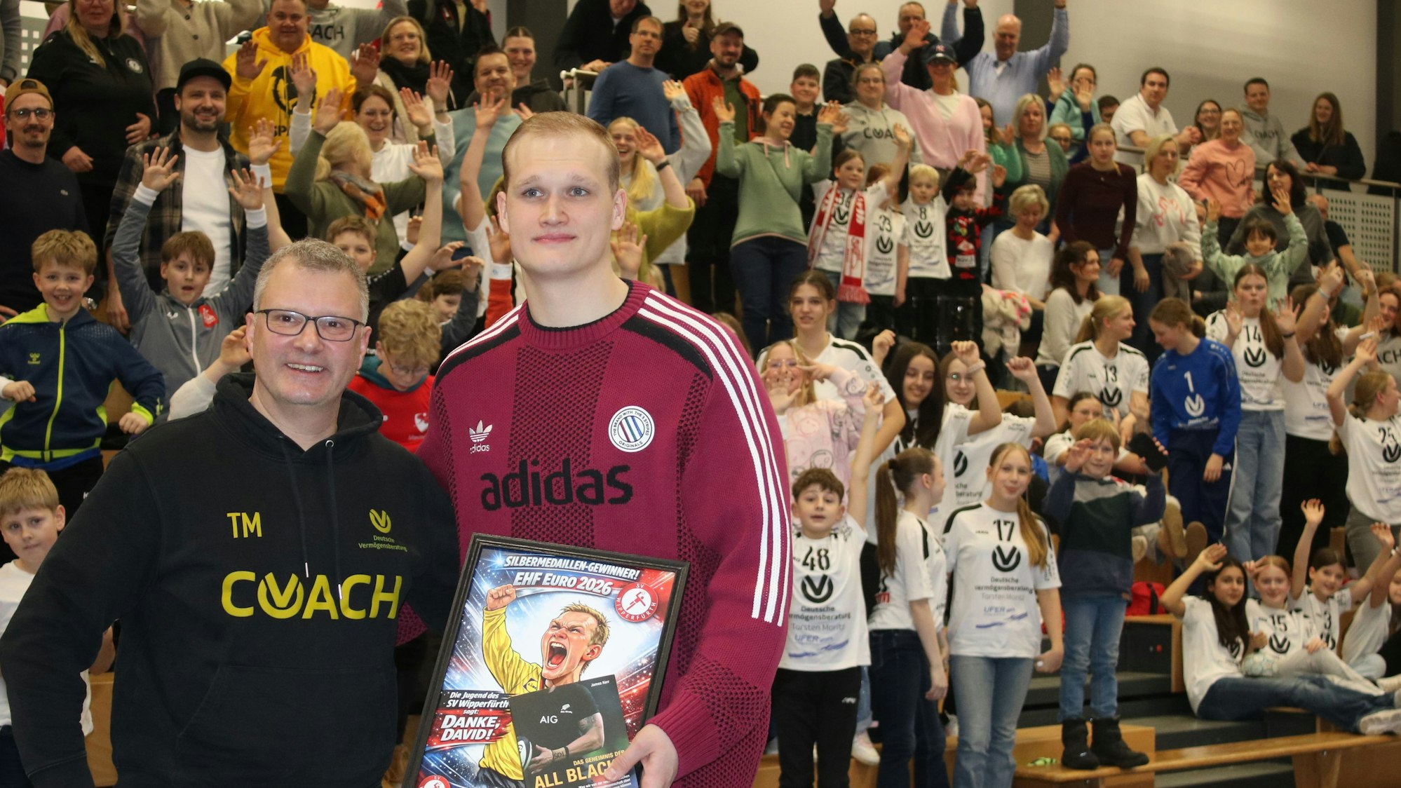 Handball-Nationaltorhüter David Späth und Torsten Moritz vor den gefüllten Rängen in der Voss-Arena.