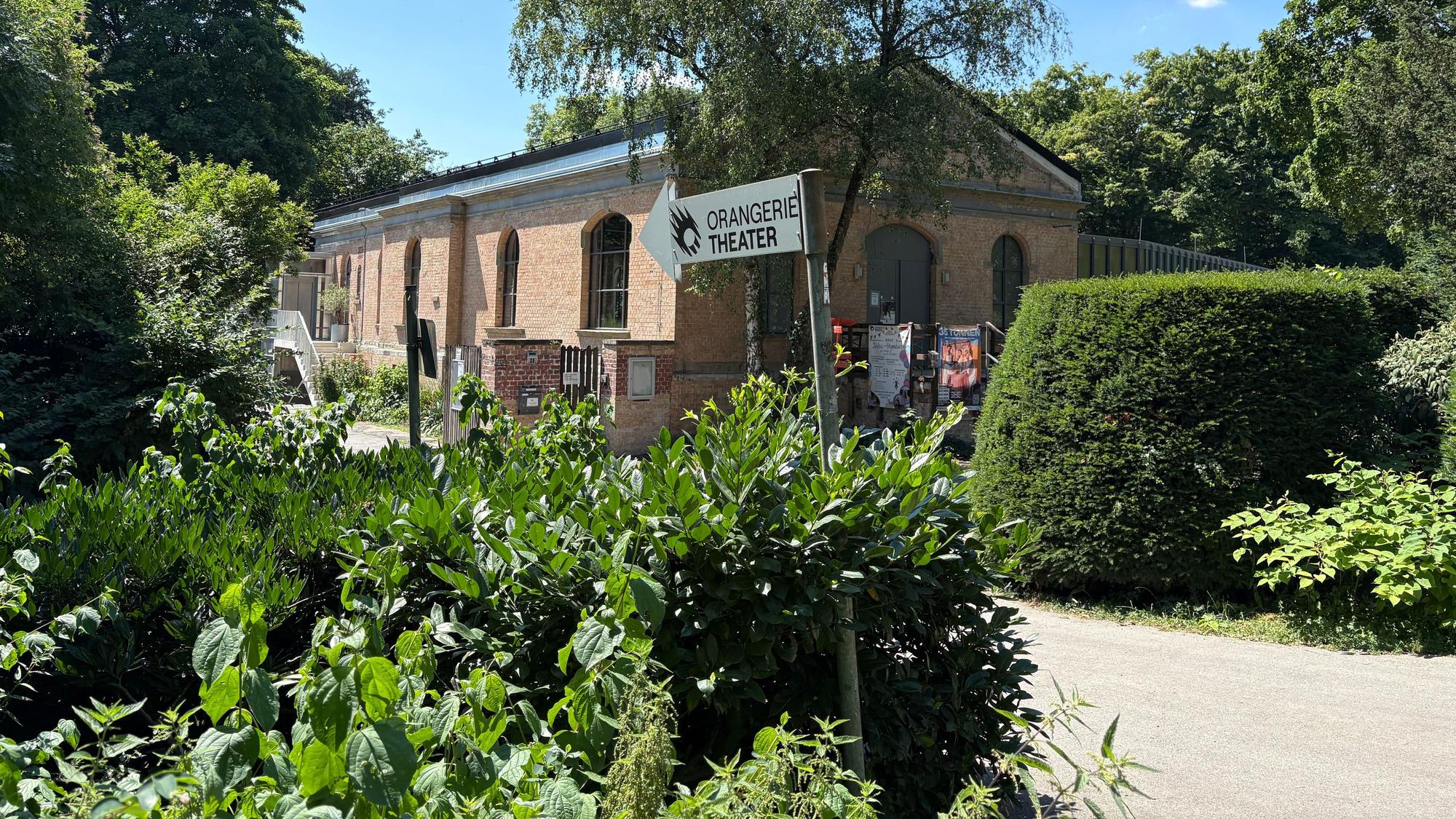 Ein Wegweiser zum Orangerie Theater im Volksgarten.