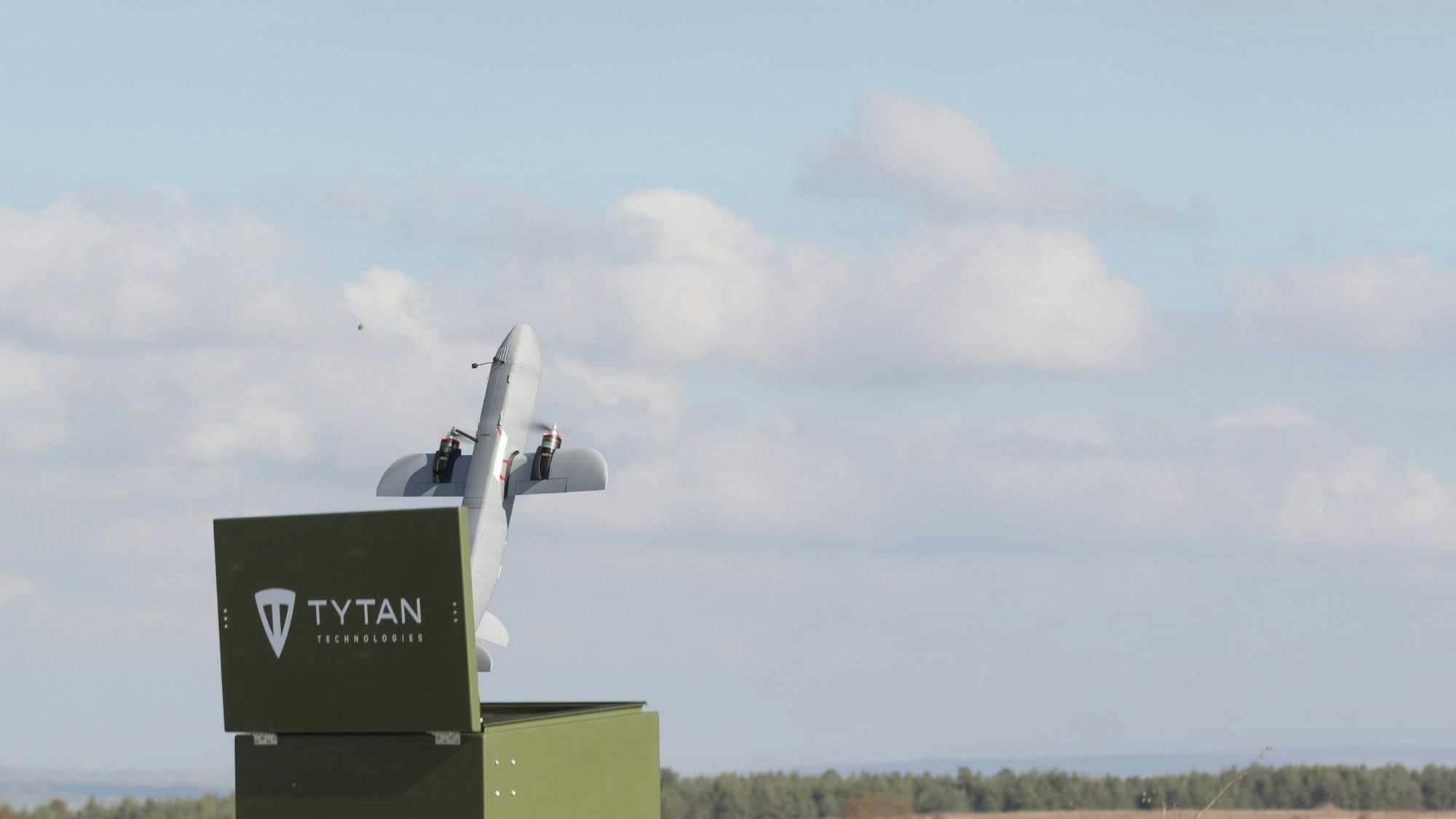 Eine Tytan-Drohne steigt aus einem kistenartig verkleideten Startsystem aus auf.