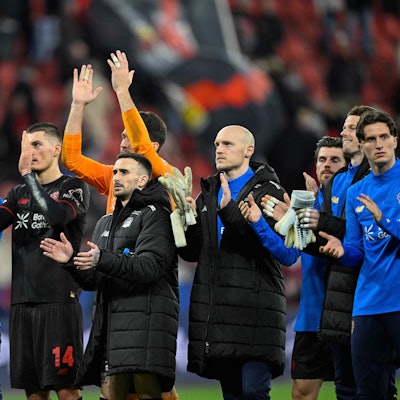Leverkusen players applaud their fans after the UEFA Champions League play-off, second-Leg football match Bayer 04 Leverkusen vs Olympiakos in Leverkusen, western Germany, on February 24, 2026. (Photo by INA FASSBENDER / AFP)