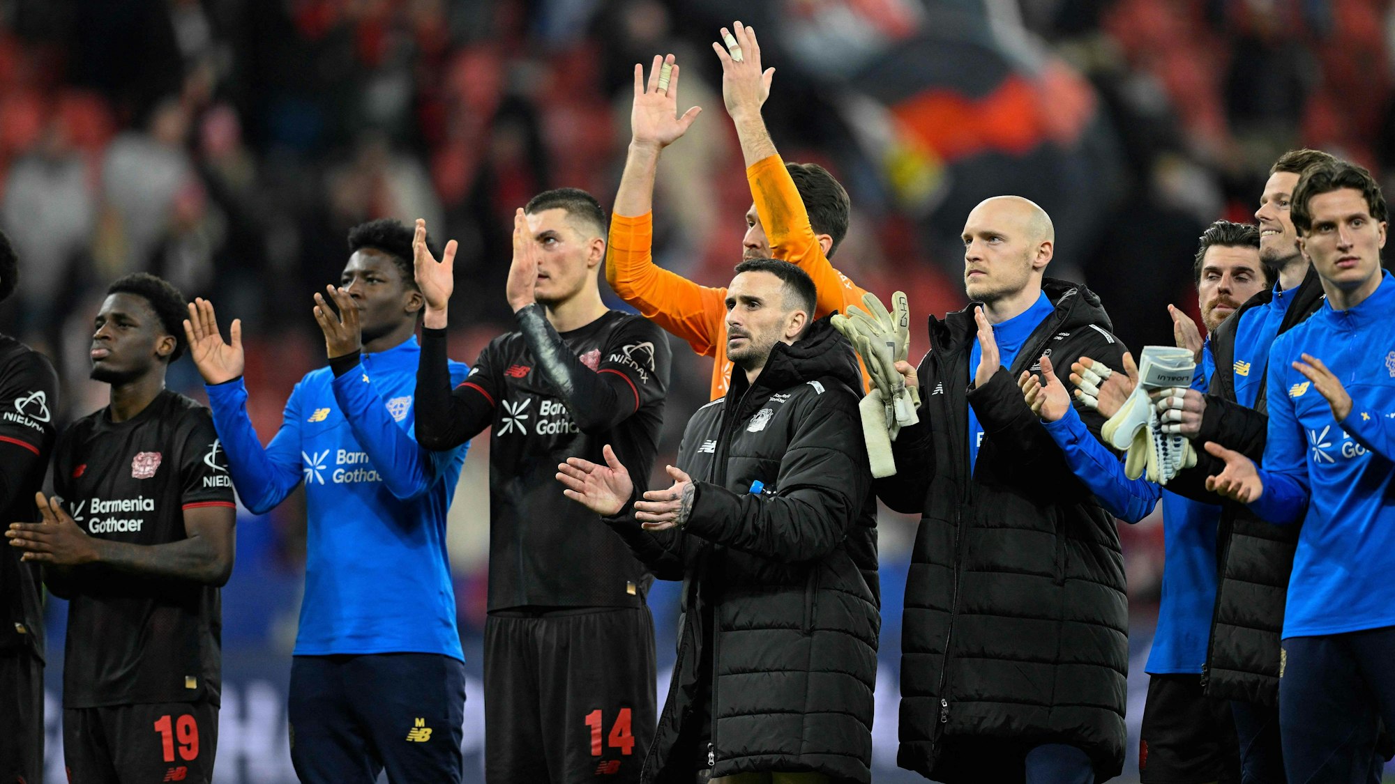 Leverkusen players applaud their fans after the UEFA Champions League play-off, second-Leg football match Bayer 04 Leverkusen vs Olympiakos in Leverkusen, western Germany, on February 24, 2026. (Photo by INA FASSBENDER / AFP)