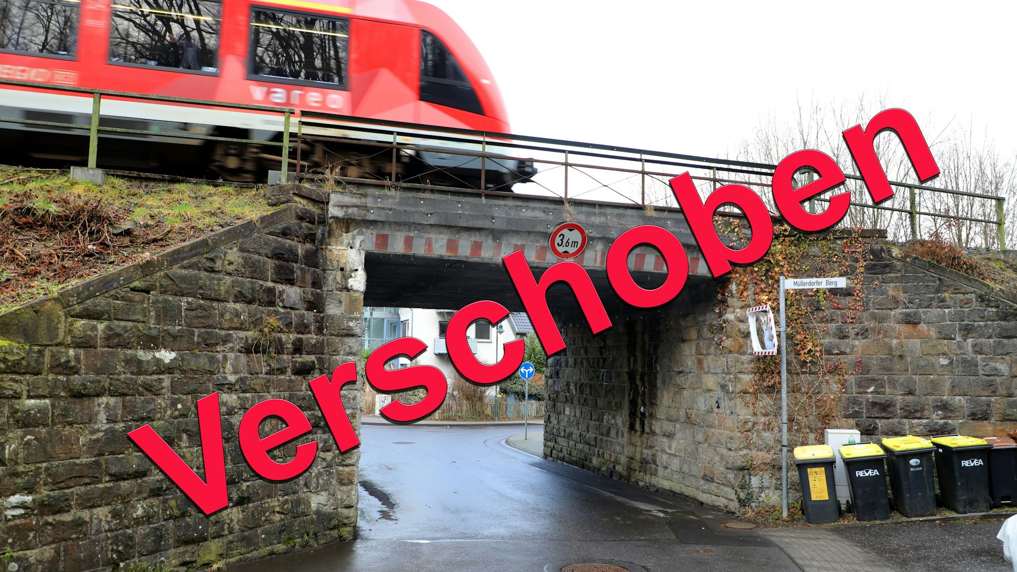 Über ein Bild der Bahnüberführung Lüghauser Straße in Rösrath-Hoffnungsthal prangt der Schriftzug „Verschoben“.
