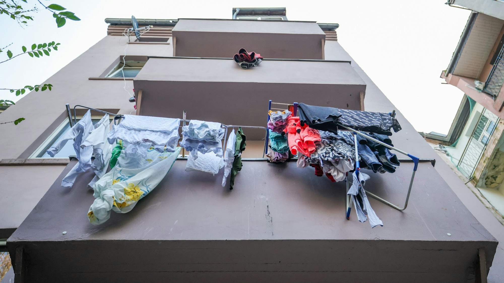 Dortmund, Razzia: Wäscheständer mit gewaschener Wäsche hängen über Balkonen eines Hauses.