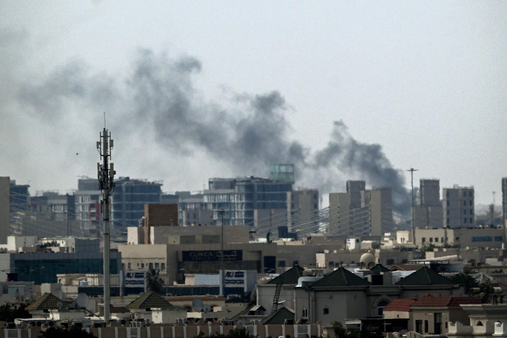 A plume of smoke rises over buildings in Doha on March 5, 2026. Multiple rounds of explosions echoed over Doha on March 5 just hours after officials said they were evacuating residents living near the US embassy. Gulf countries have been targeted by repeated waves of Iranian drone and missile attacks in retaliation for the massive US-Israeli air campaign. (Photo by Mahmud Hams / AFP)