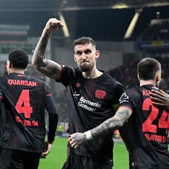 TOPSHOT - Bayer Leverkusen's German midfielder #08 Robert Andrich (2L) and teammates celebrate scoring their team's first goal during the UEFA Champions League, Last 16, first-leg football match Bayer 04 Leverkusen vs Arsenal in Leverkusen, western Germany, on March 11, 2026. (Photo by UWE KRAFT / AFP)