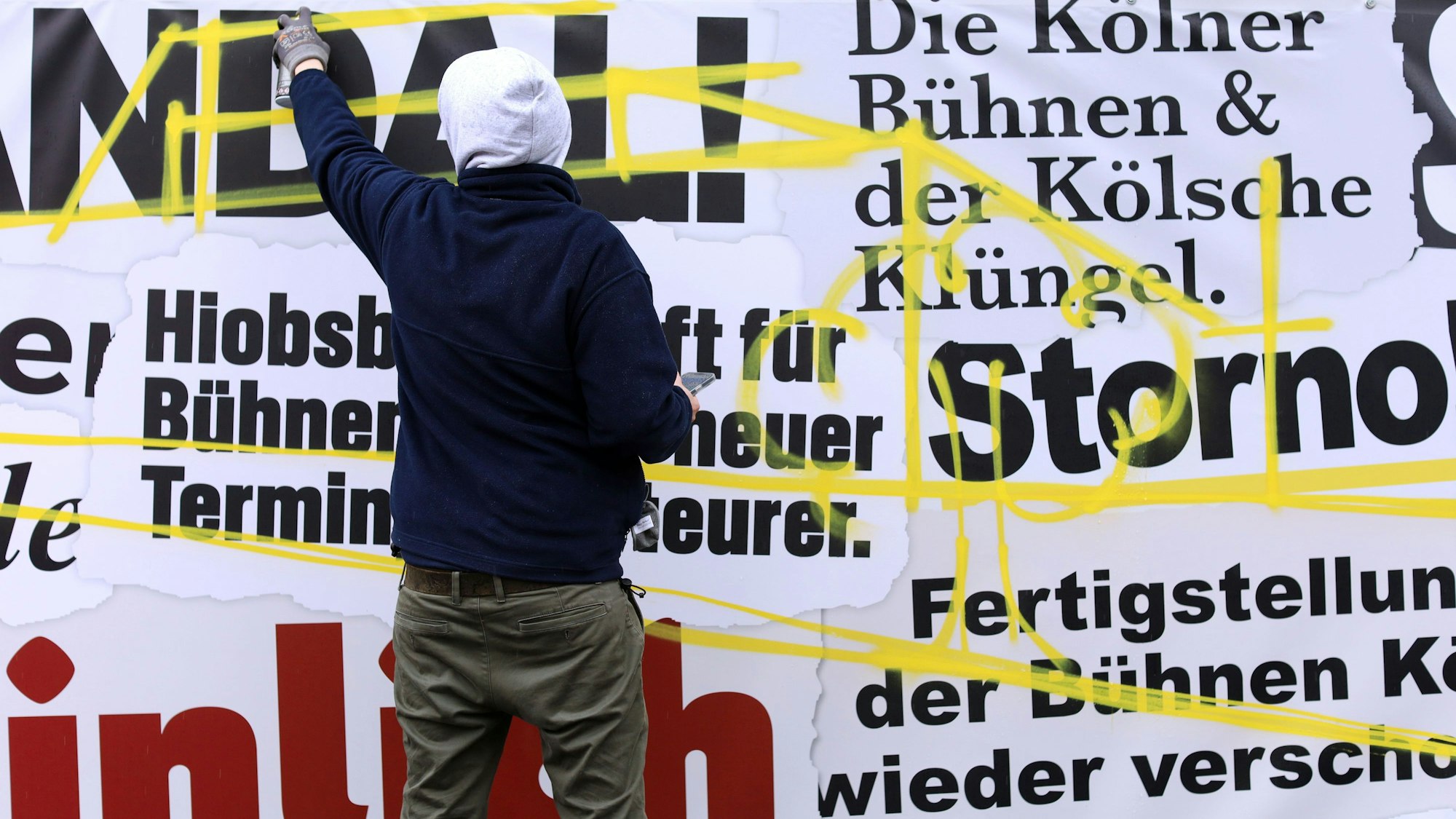 Ein Künstler gestaltet den Frustzaun an der Oper um.