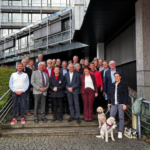 Männer und Frauen stehen auf der Treppe vor dem Siegburger Kreishaus.