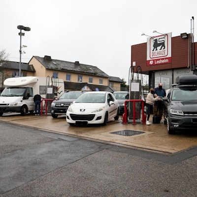 Autos stehen in vier Reihen an den Zapfsäulen.