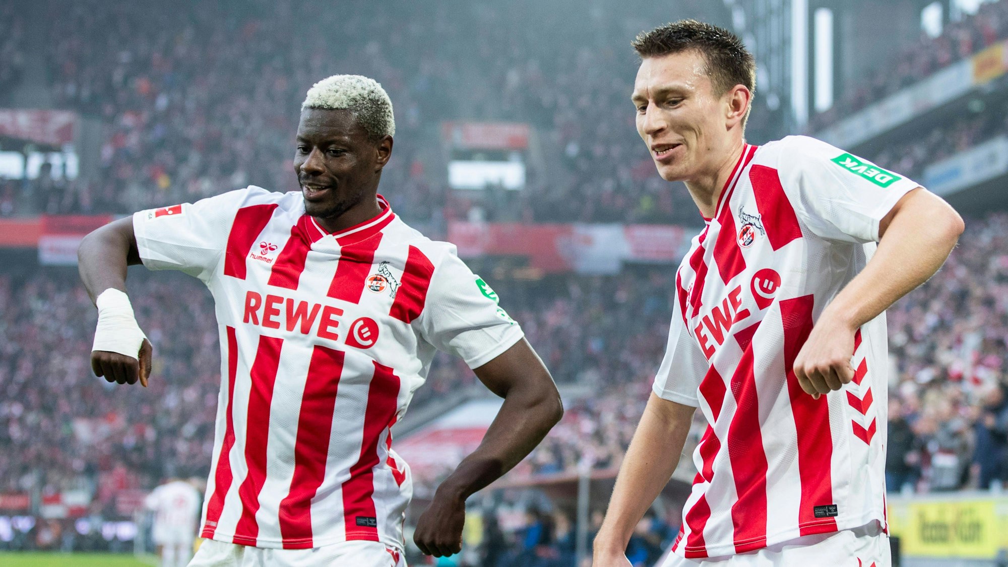 COLOGNE, GERMANY - FEBRUARY 21: Goal celebration of Ragnar Ache 1. FC Koeln, 9 and Kristoffer Lund 1. FC Koeln, 32 during the Bundesliga match between 1. FC Koeln vs. TSG 1899 Hoffenheim on matchday 23 at RheinEnergie-Stadion on February 21st, 2026 in Cologne, Germany. DFL regulations prohibit any use of photographs as image sequences and/or quasi-video NRW Germany Copyright: xBEAUTIFULxSPORTS/JulianxMeuselx