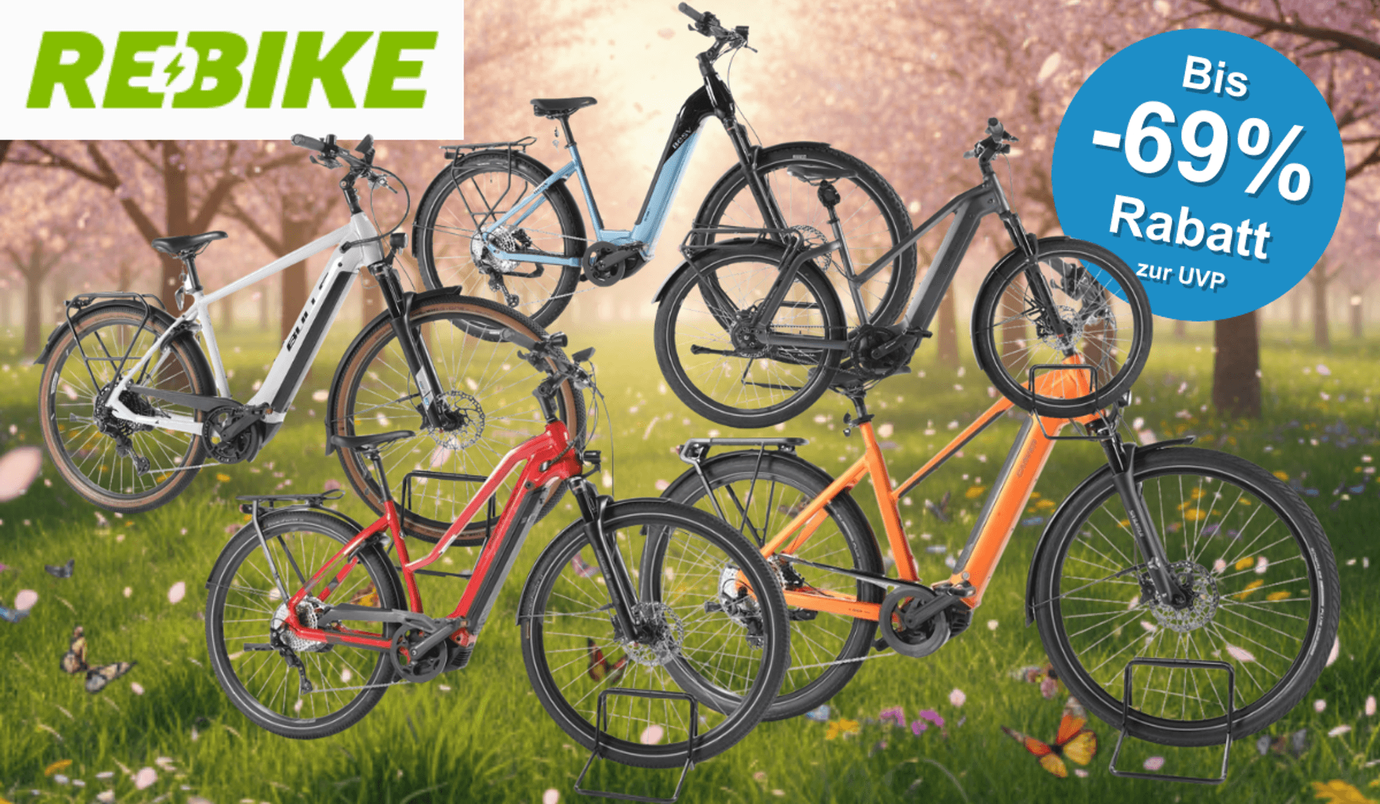 E-Bikes Trekking, City und E-Mountain-Bikes verschiedener Marken vor einer grünen Wiese mit bunten Blumen und blühenden Bäumen.