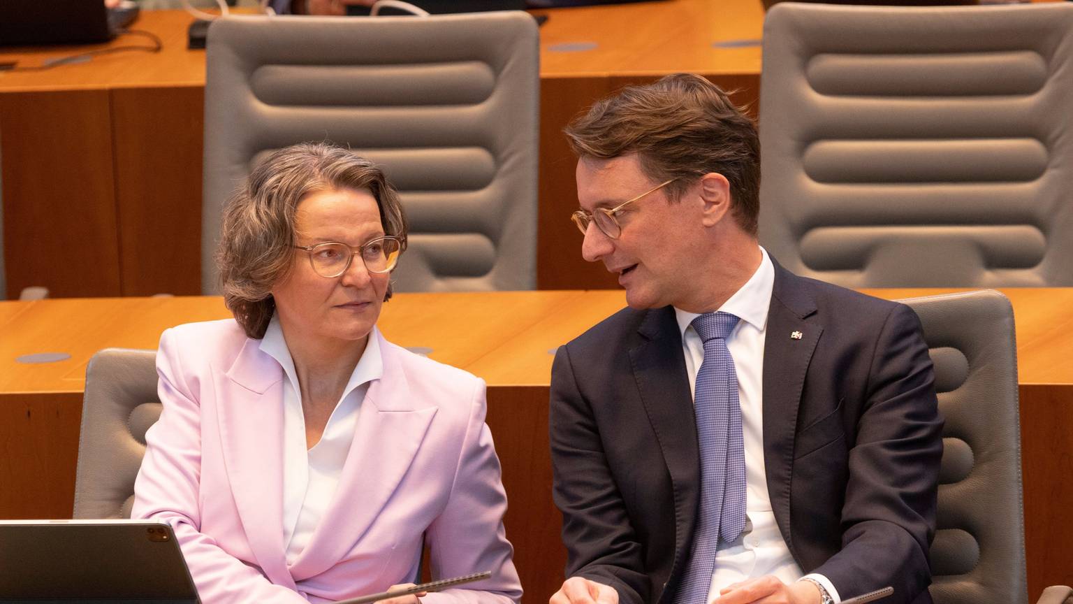 Ina Scharrenbach (CDU), Ministerin für Heimat, Kommunales, Bau und Gleichstellung von NRW, und Hendrik Wüst (CDU), Ministerpräsident von NRW, unterhalten sich im Plenum des Landtags.