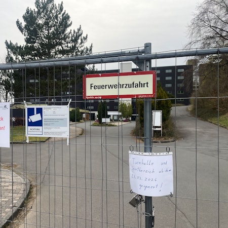 An der verschlossenen Zufahrt zum früheren Klinikgebäude weist ein Zettel darauf hin, dass Turnhalle und Sportbereich gesperrt sind.