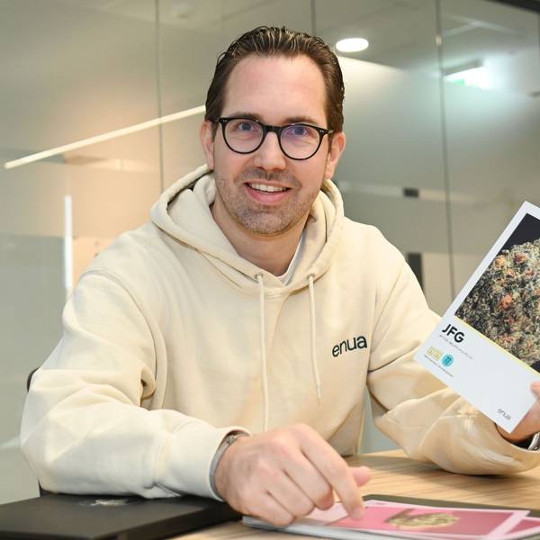 Albert Schwarzmeier zeigt eine Informationskarte, auf der die Eigenschaften einer Cannabis-Sorte (Strain) erklärt werden.