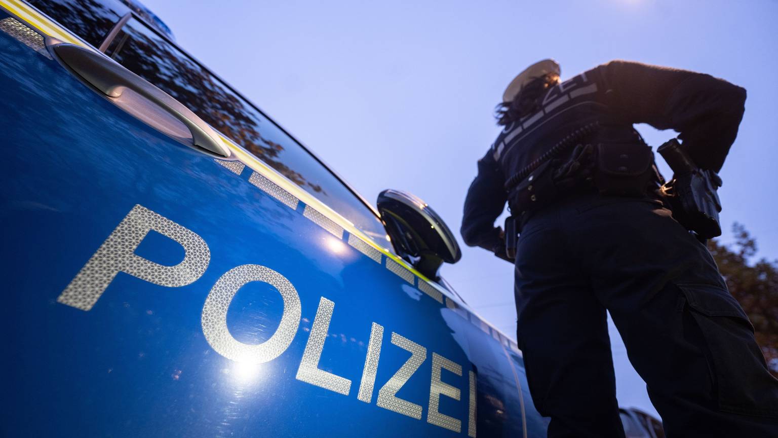Eine Polizistin steht neben einem Polizeifahrzeug. (zu dpa: «Bei Festnahme: Mann verletzt Polizistin mit Messer») Foto: Marijan Murat/dpa +++ dpa-Bildfunk +++