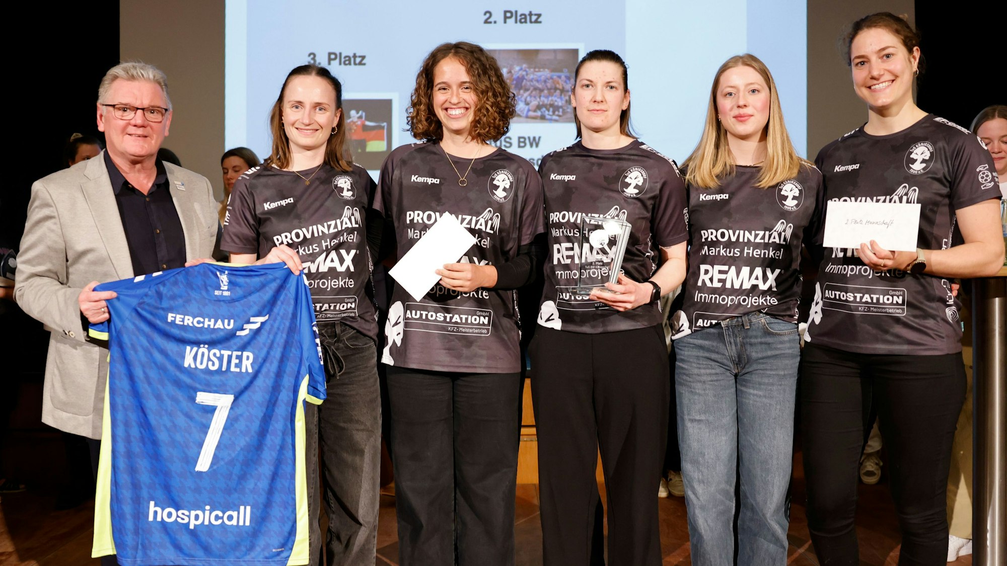 Ein signierte Trikot von Handballnationalspieler Julian Köster überreiche Stefan Klett an die Handballerinnen vom TuS Königsdorf.