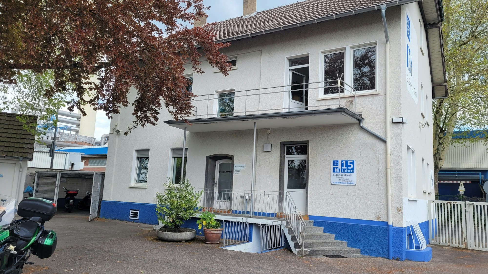 Das Haus der GL Service ist weiß mit einem blauen Fundament.