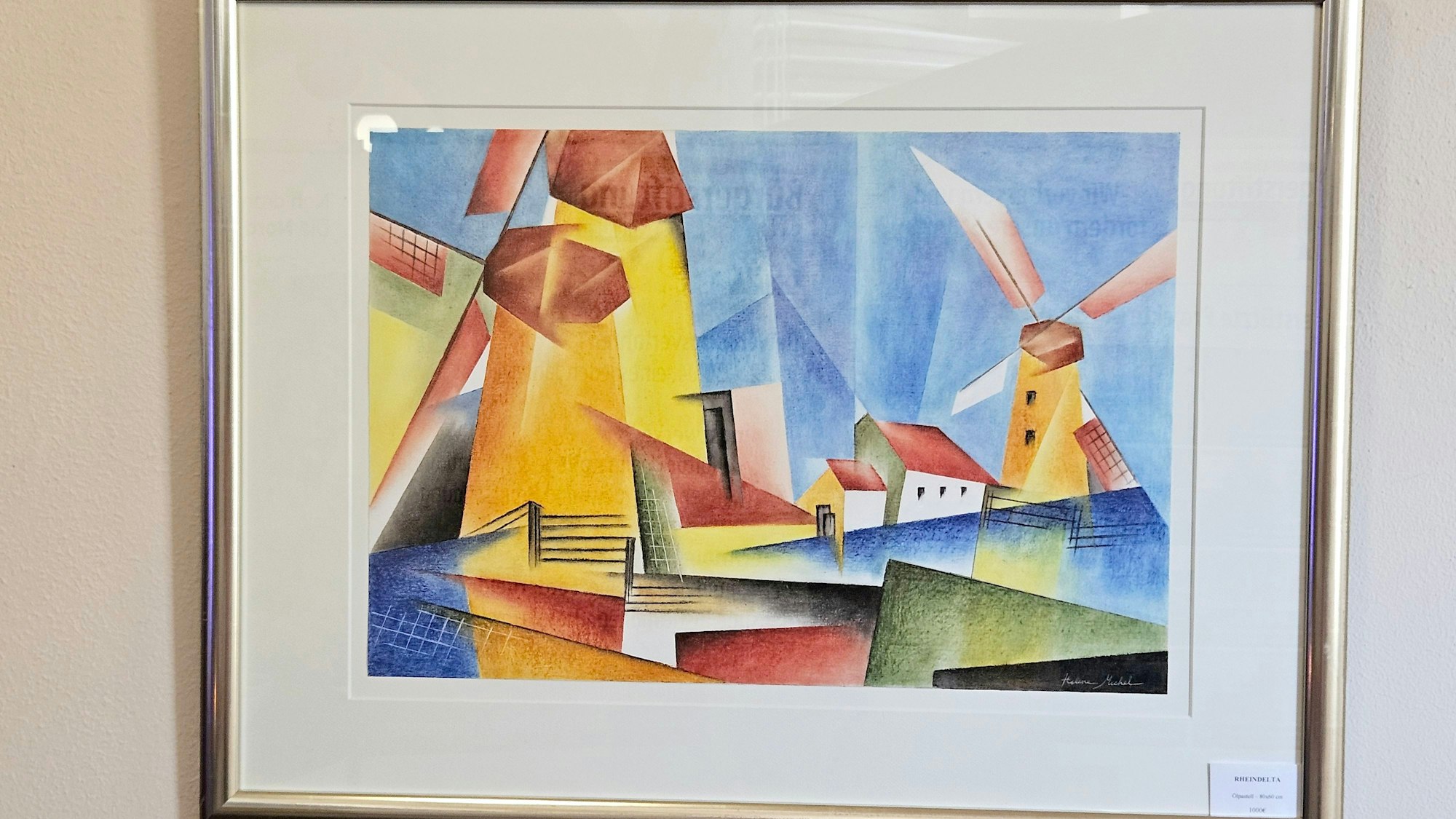 Mehrere Windmühlen und Häuser sind auf dem Bild zu sehen.