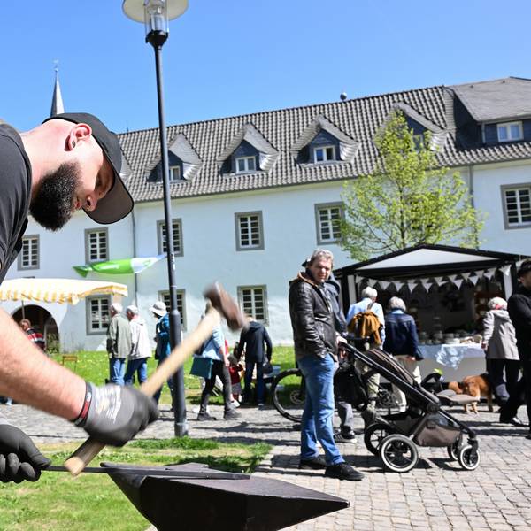 Ein Schmied hat mit einem Hammer auf ein Stück Eisen.
