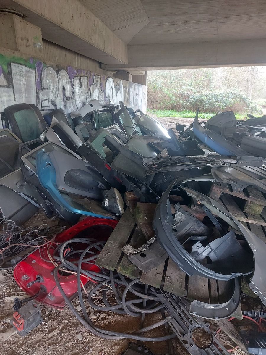 Autoteile und Glasscheiben an einer Autobahnunterführung