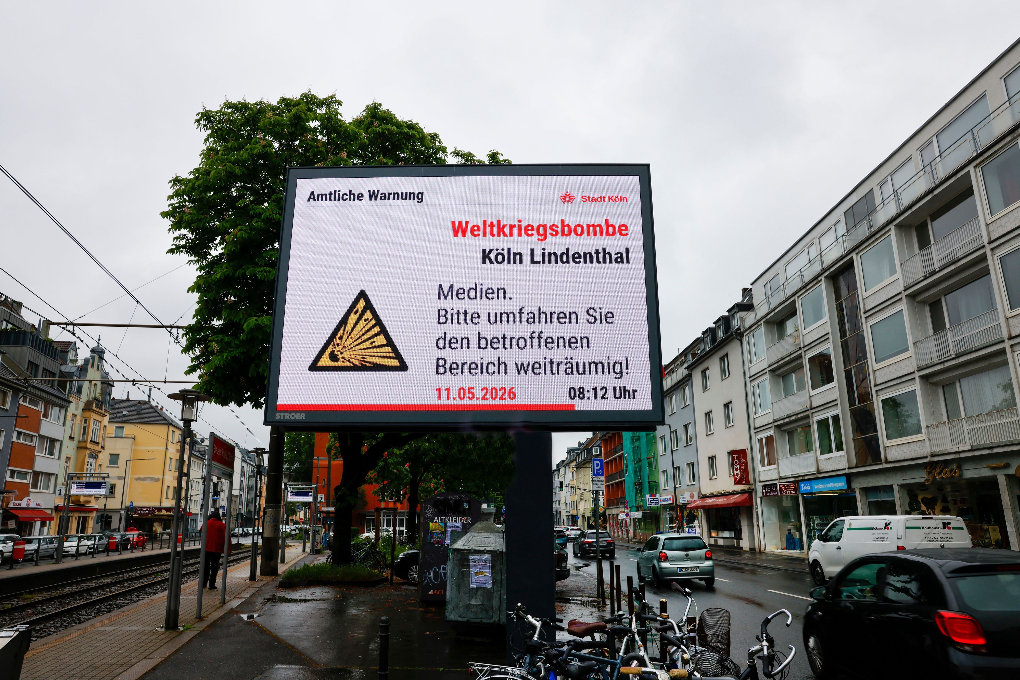 11.05.2026, Nordrhein-Westfalen, Köln: Auf einem Werbedisplay wird auf die Weltkriegsbombe in Lindenthal hingewiesen. Foto: Thomas Banneyer/dpa +++ dpa-Bildfunk +++