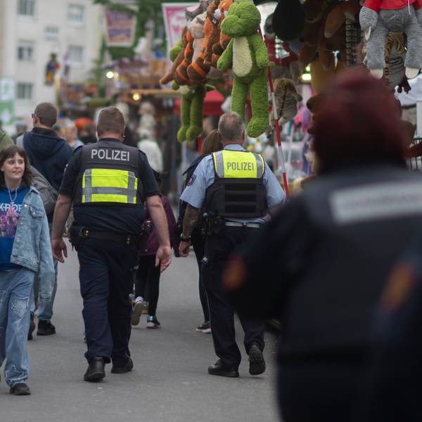 Das Bild zeigt Mitarbeitende des Ordnungsamts und der Polizei, während sie auf der Kirmes Streife gehen.