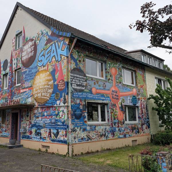 Das Foto zeigt das Haus mit seinen bunt bemalten Fassaden.