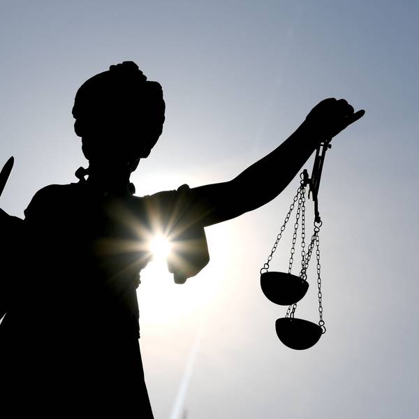 Die Göttin Justitia im Gegenlicht auf dem Gerechtigkeitsbrunnen in Frankfurt am Main.