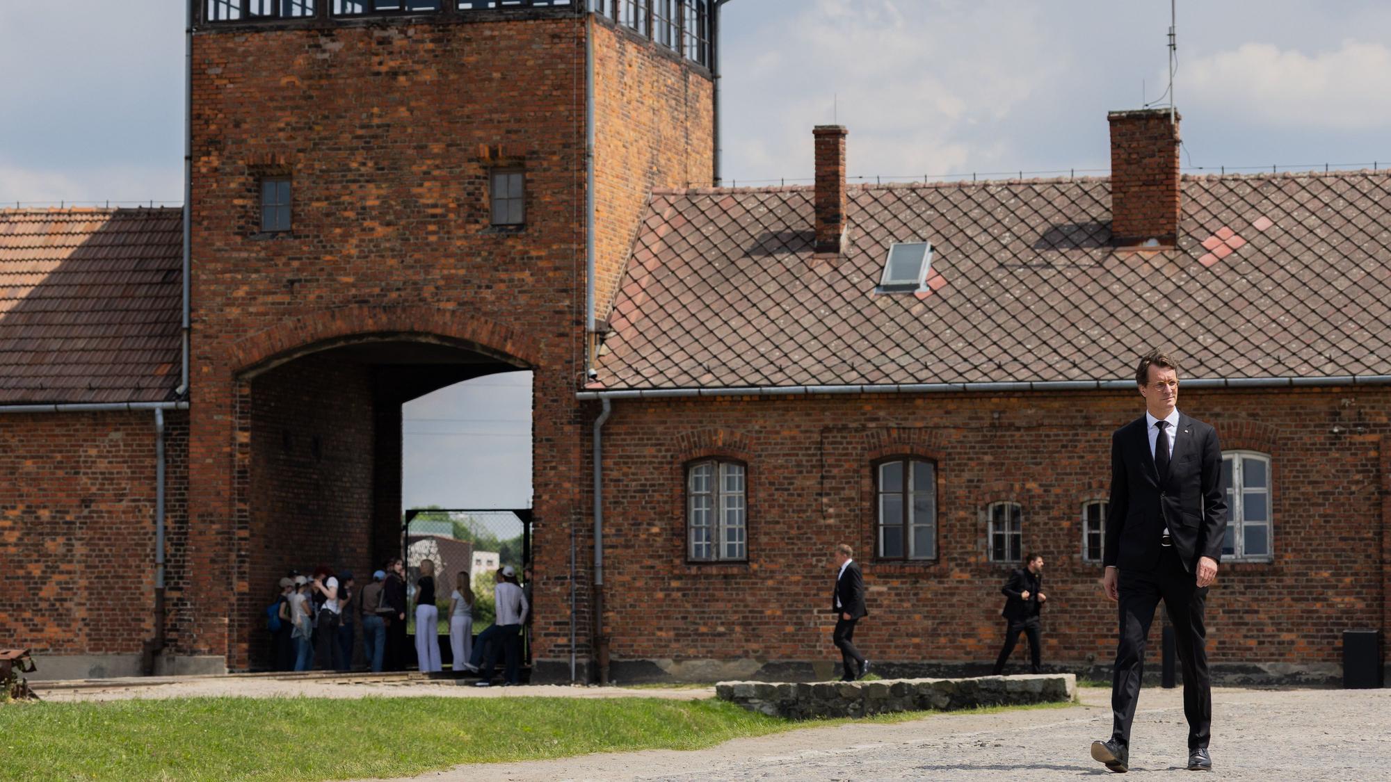 Hendrik Wüst (CDU), Ministerpräsident von Nordrhein-Westfalen, betritt durch das Tor das ehemalige Konzentrations- und Vernichtungslager Auschwitz-Birkenau (Auschwitz II).