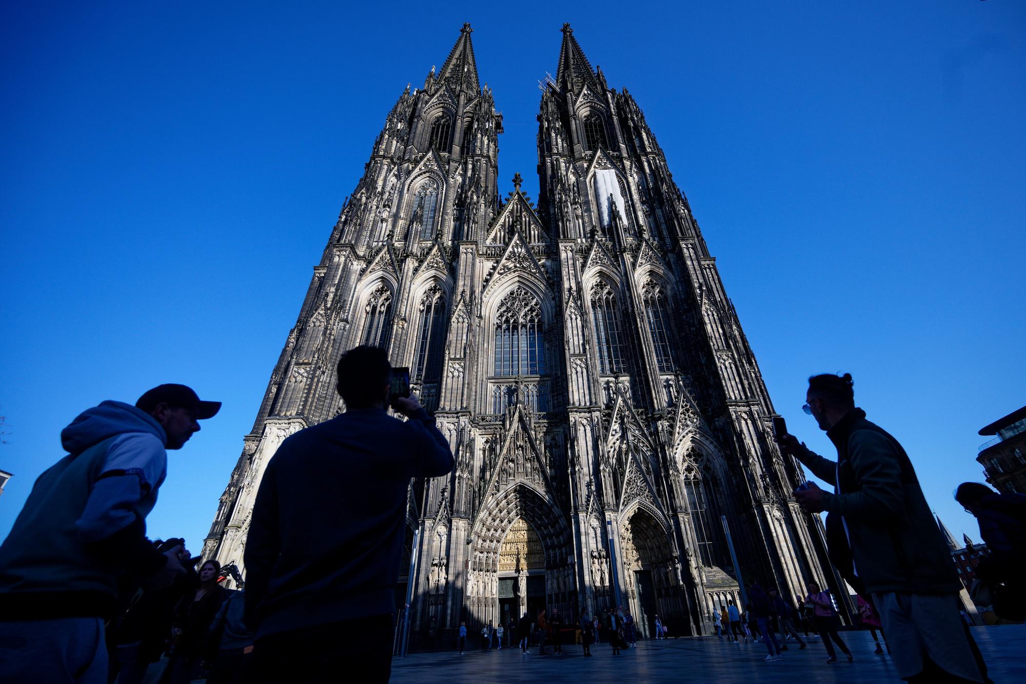 Touristen fotografieren den Kölner Dom. (Archivbild)