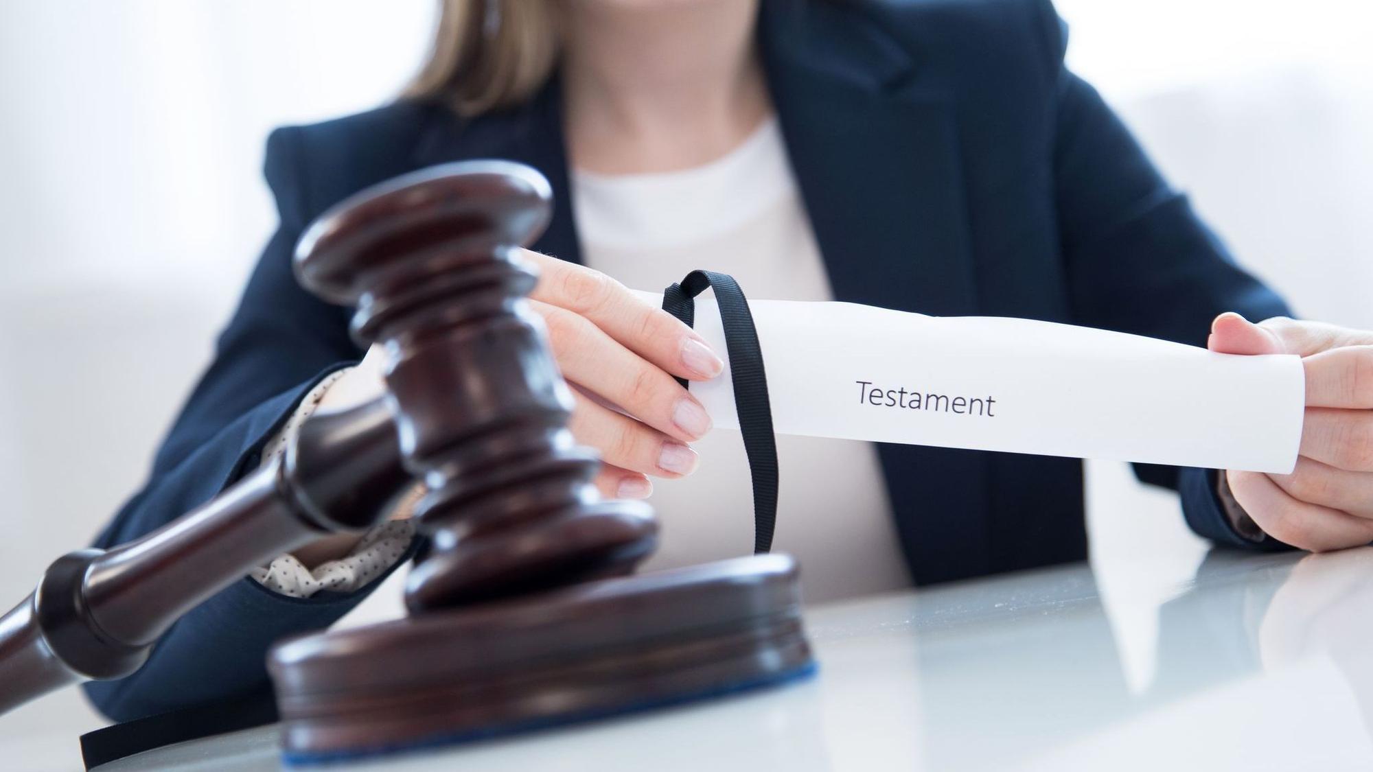 Eine Frau hält ein Testament in den Händen