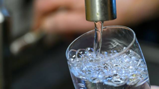 ARCHIV – 24.07.2025, Sachsen, Chemnitz: Trinkwasser läuft in einer Küche in Chemnitz in ein Glas. (zu dpa: „Wegen Keimen: Leitungswasser in zwei Gemeinden wird gechlort“) Foto: Hendrik Schmidt/dpa +++ dpa-Bildfunk +++