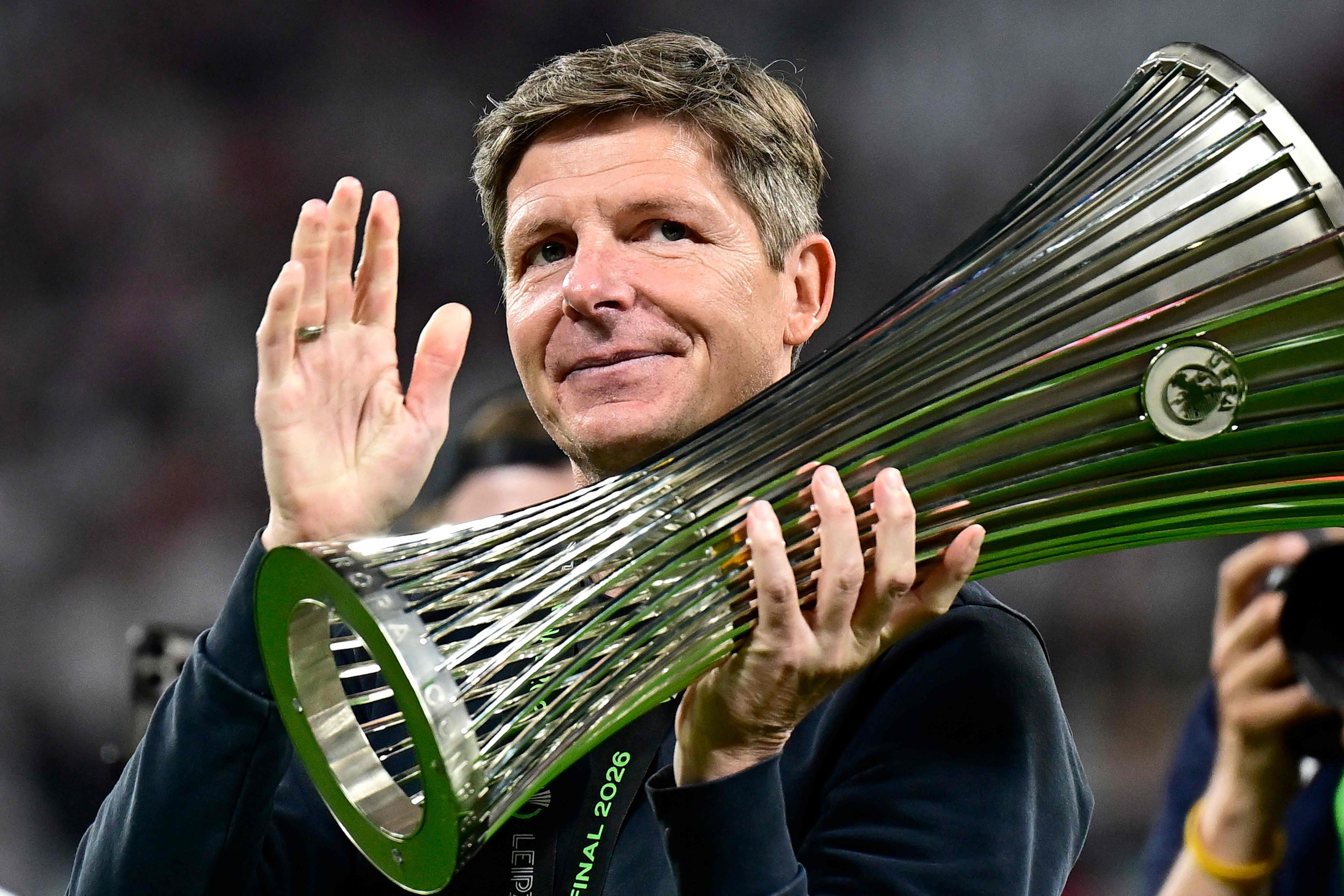 TOPSHOT - Crystal Palace's Austrian manager Oliver Glasner holds the trophy after his team won the UEFA Conference League final football match between Crystal Palace FC and Rayo Vallecano de Madrid in Leipzig, eastern Germany, on May 27, 2026. (Photo by Tobias SCHWARZ / AFP)