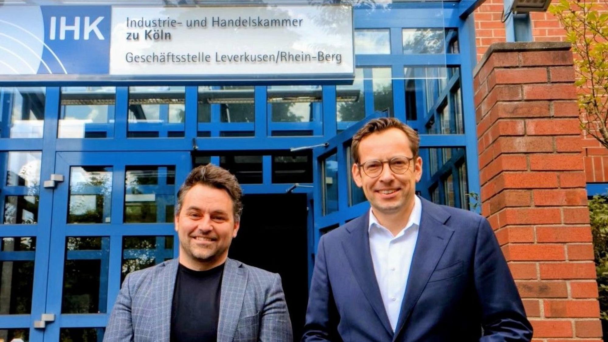 Zwei Männer stehen vor der IHK-Geschäftsstelle in Opladen.