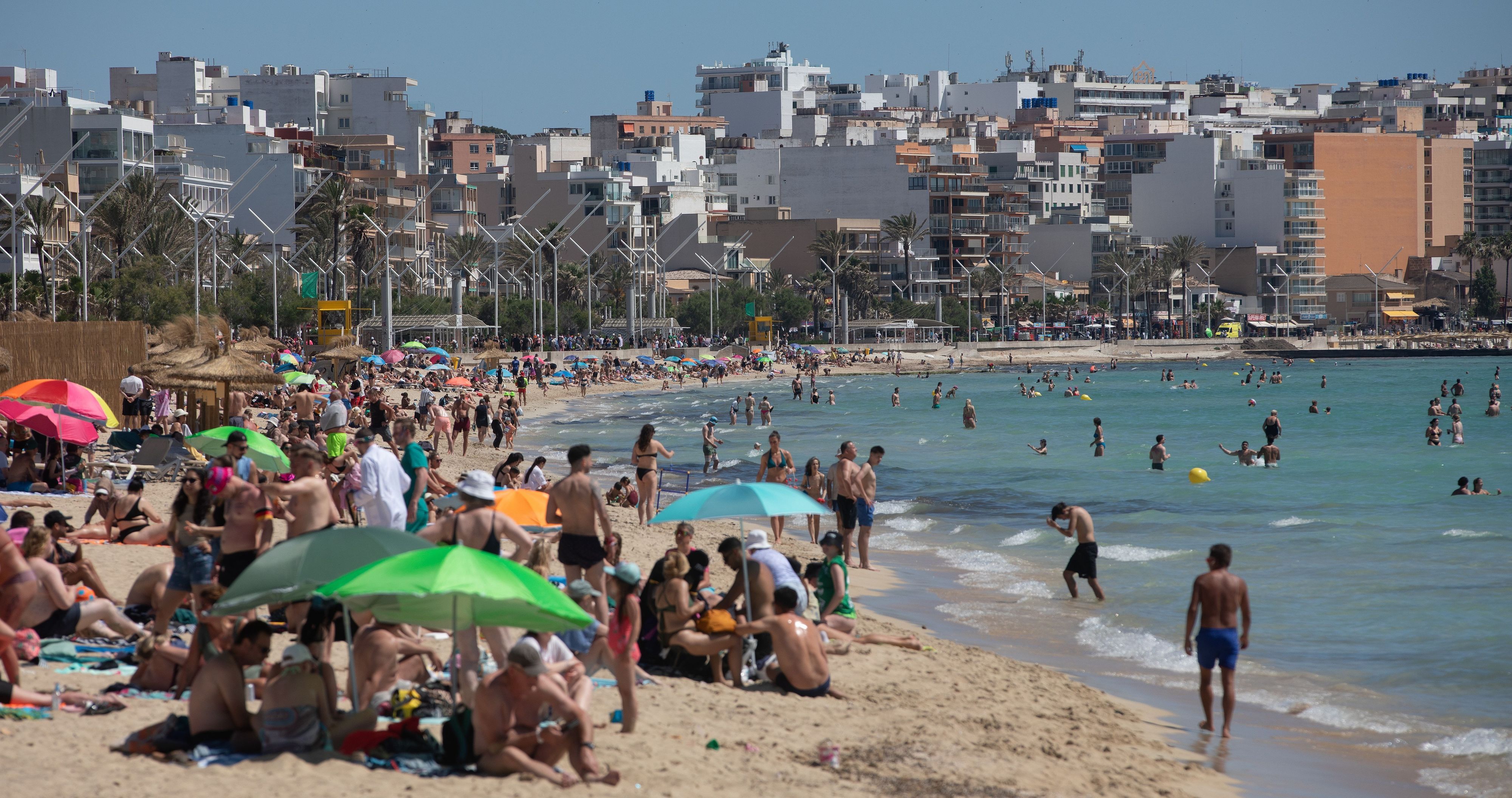 Menschen sonnen sich und schwimmen am Strand Playa de Palma auf Mallorca. Eurowings-Flüge waren neun Prozent öfter gefragt als im Vorjahr.