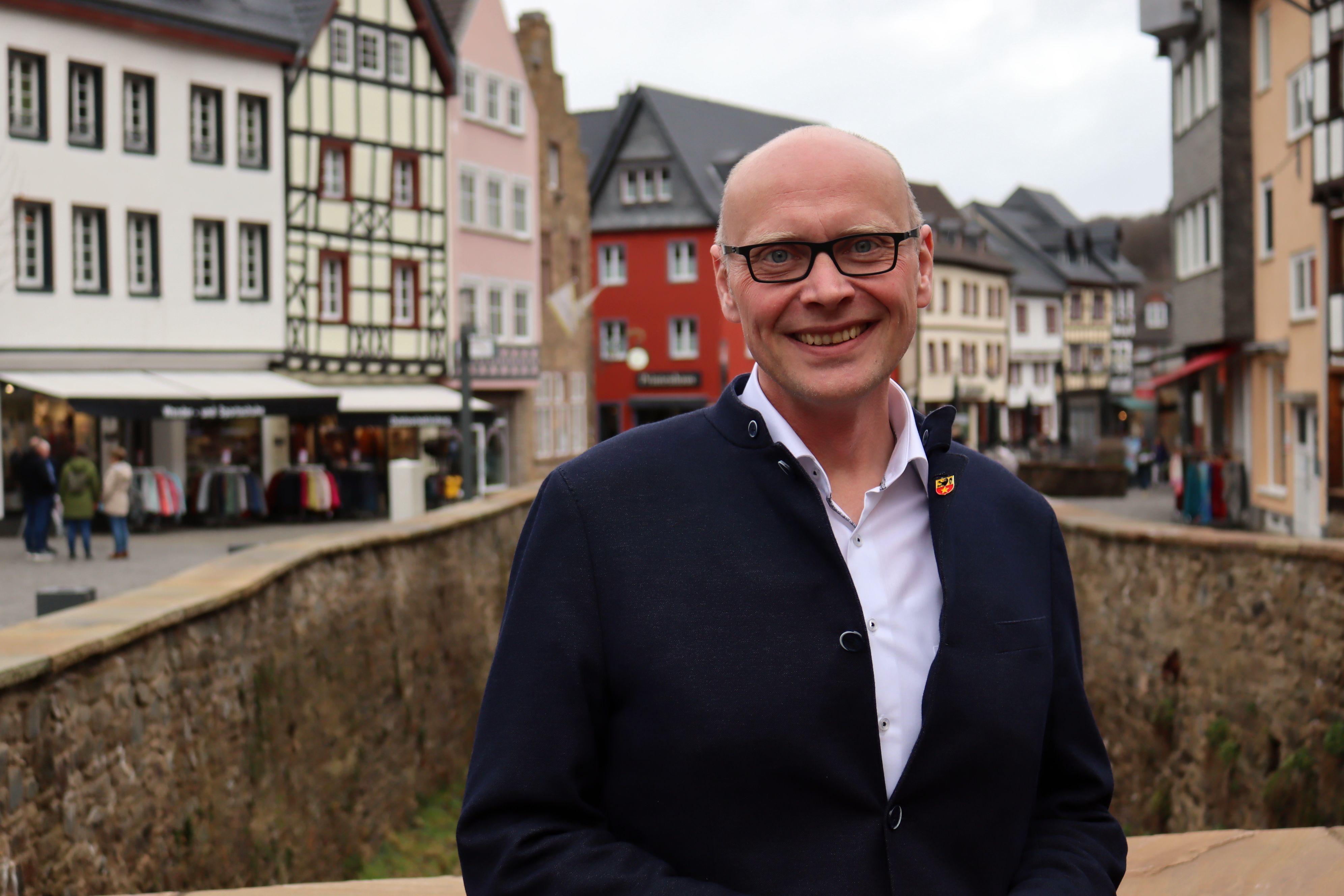 Sebastian Glatzel steht auf einer Brücke, im Hintergrund die Häuser von Bad Münstereifel.